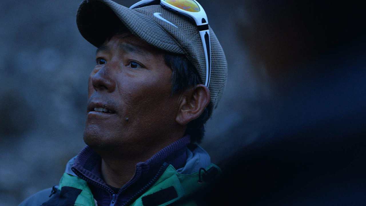 a man with a baseball cap and sunglasses